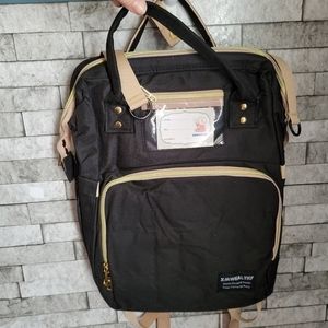 XMWealthy NWOT baby diaper bag with fold‎ out crib, with pad charging port